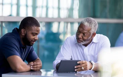 two men discussing and smilling