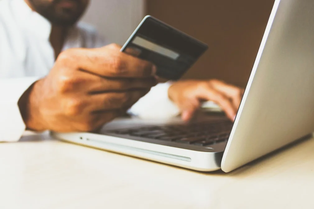 a man submitting his credit card details on a form online